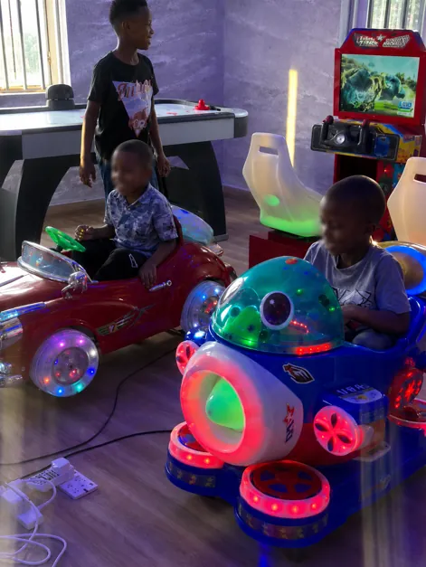 Children enjoying indoor rides at Olango
